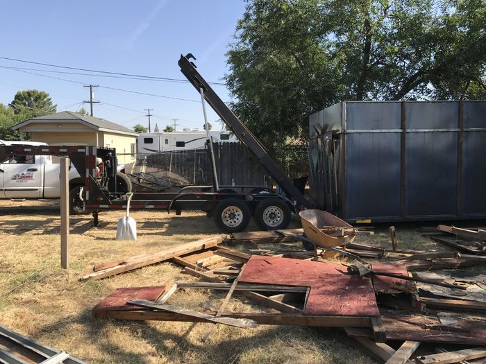 Boom truck setting a large steel container during an equipment set
