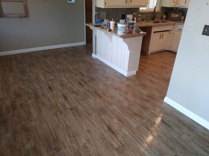Open concept kitchen remodel opening onto a living area with hardwood flooring