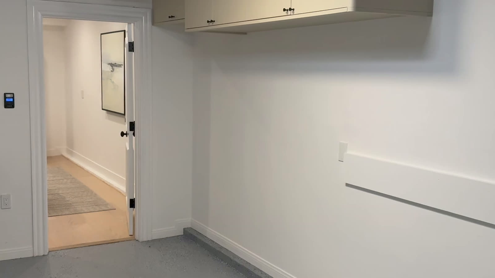 Completed interior with continuous wall protection and handrail run through to the corridor
