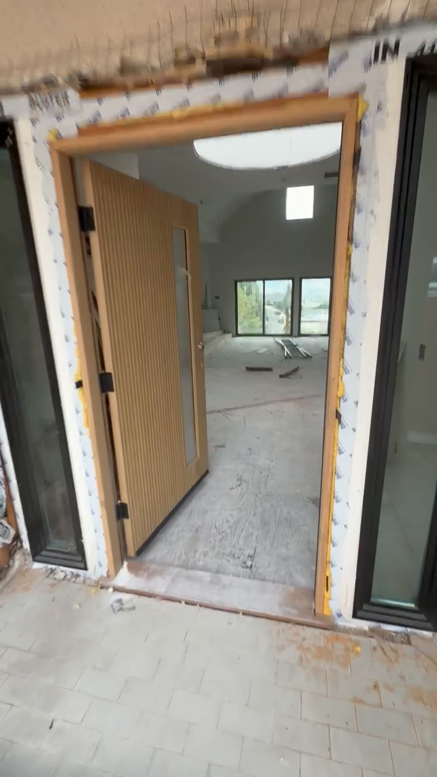 New entry doorway framed and protected part way through a commercial build-out