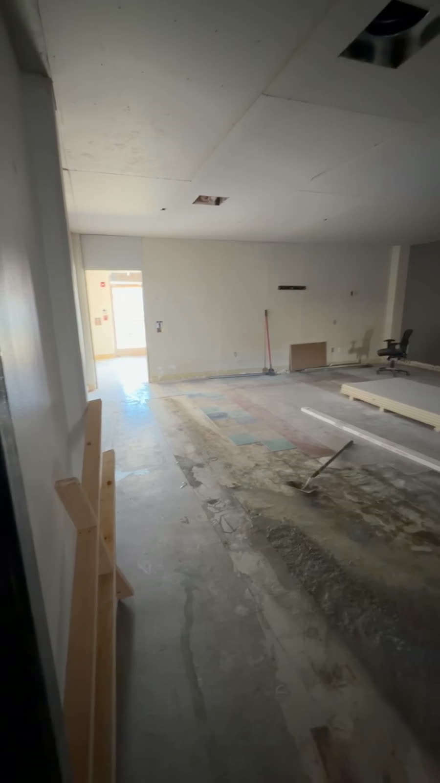 Commercial interior part way through build-out with new partitions framed and the slab swept ahead of finishes