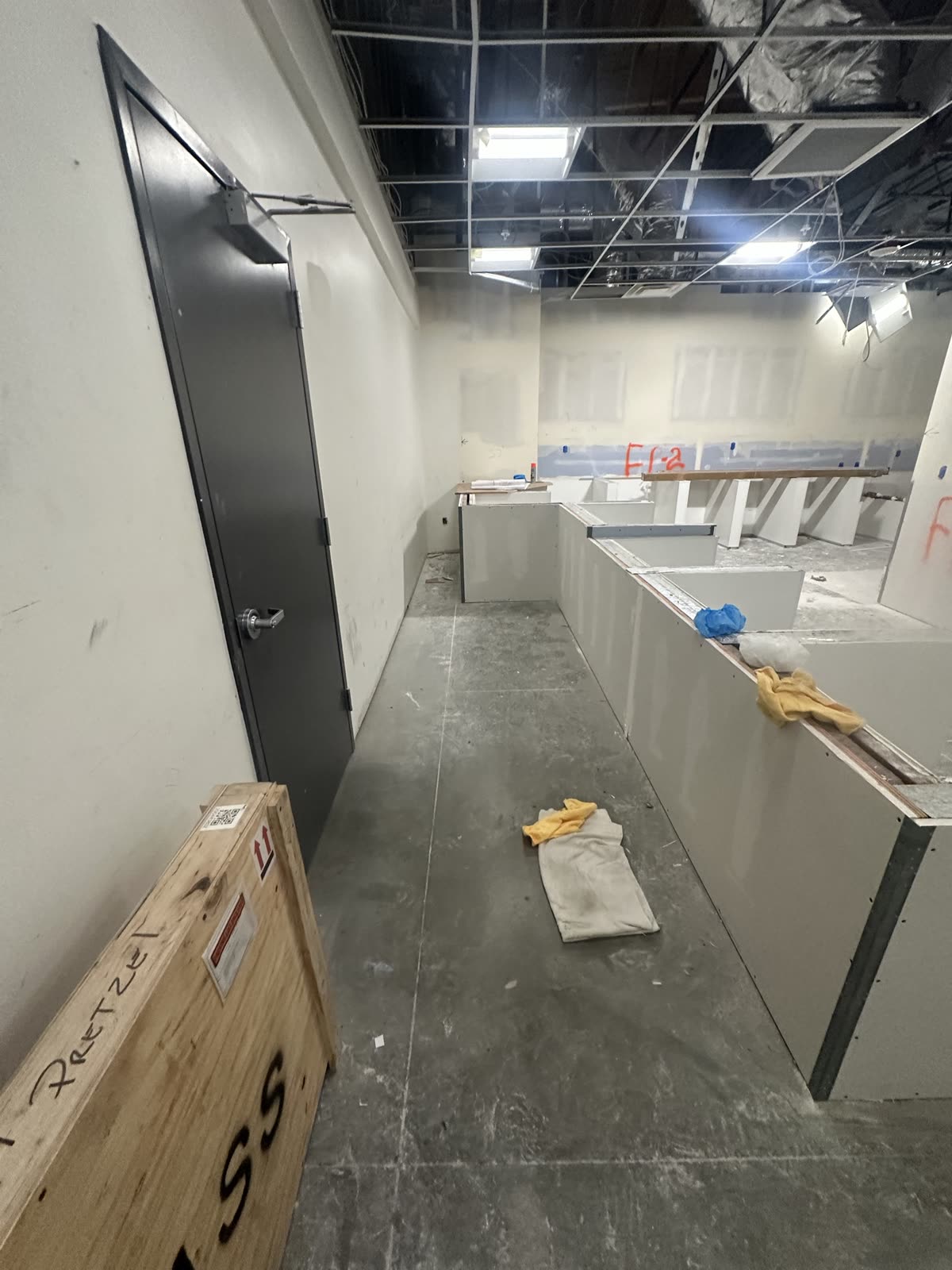 Commercial counter under construction with equipment still crated on the floor beside it