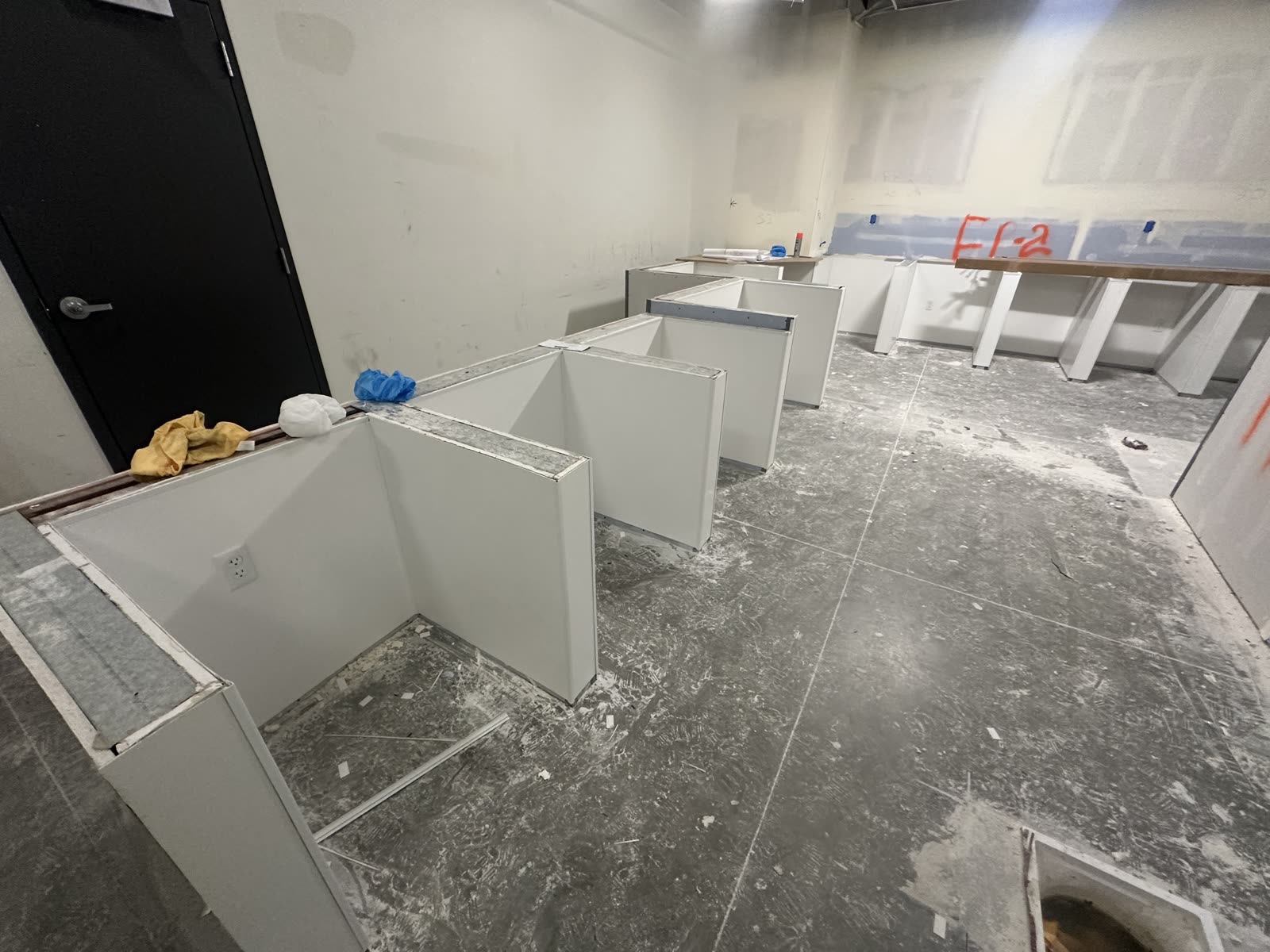 Drywall partitions taped and marked up with fire-protection references ahead of finishing