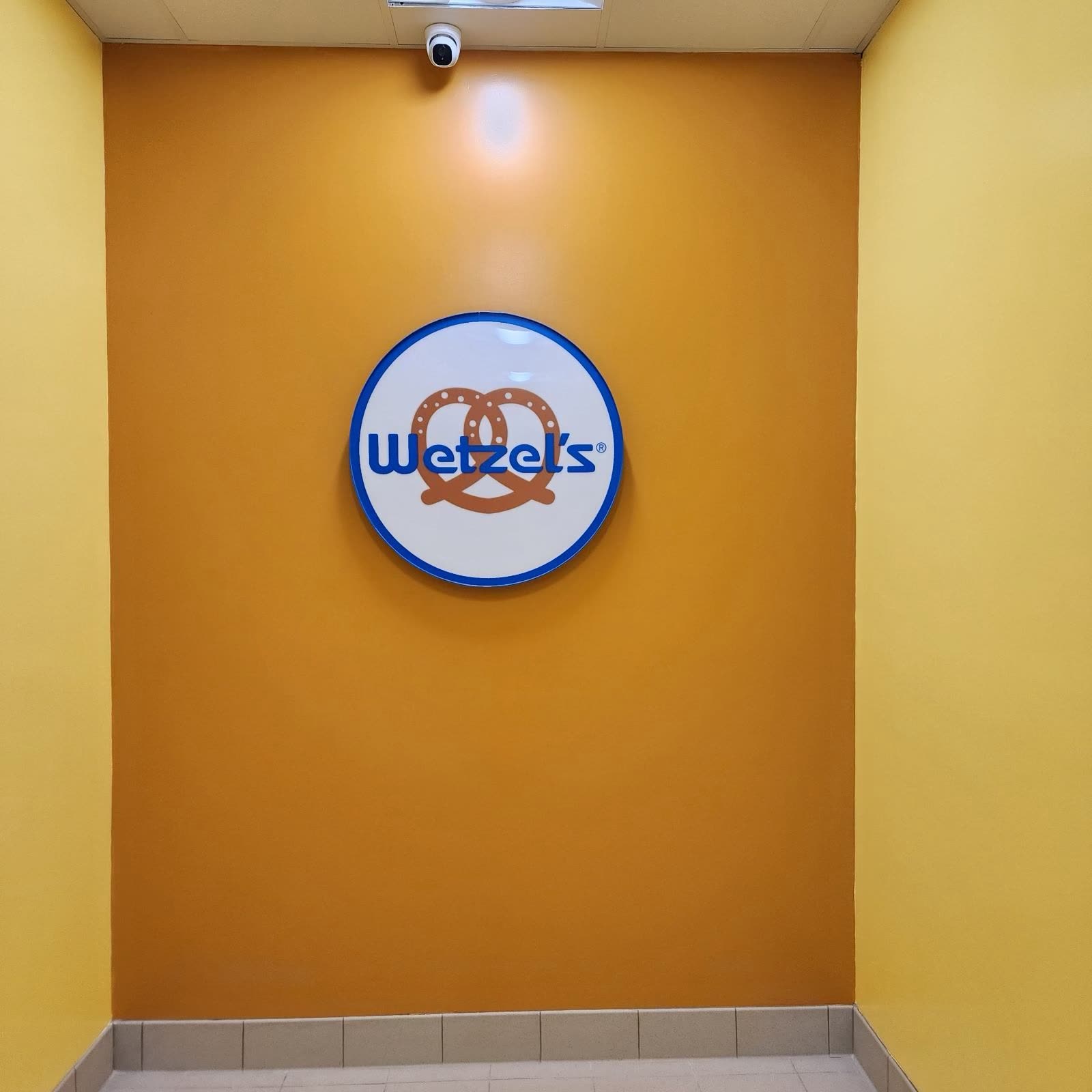 Finished feature wall in the completed unit with the tenant logo mounted and lit
