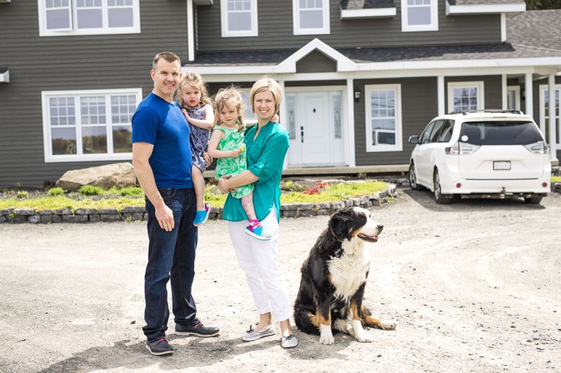 Homeowners standing in front of their completed home